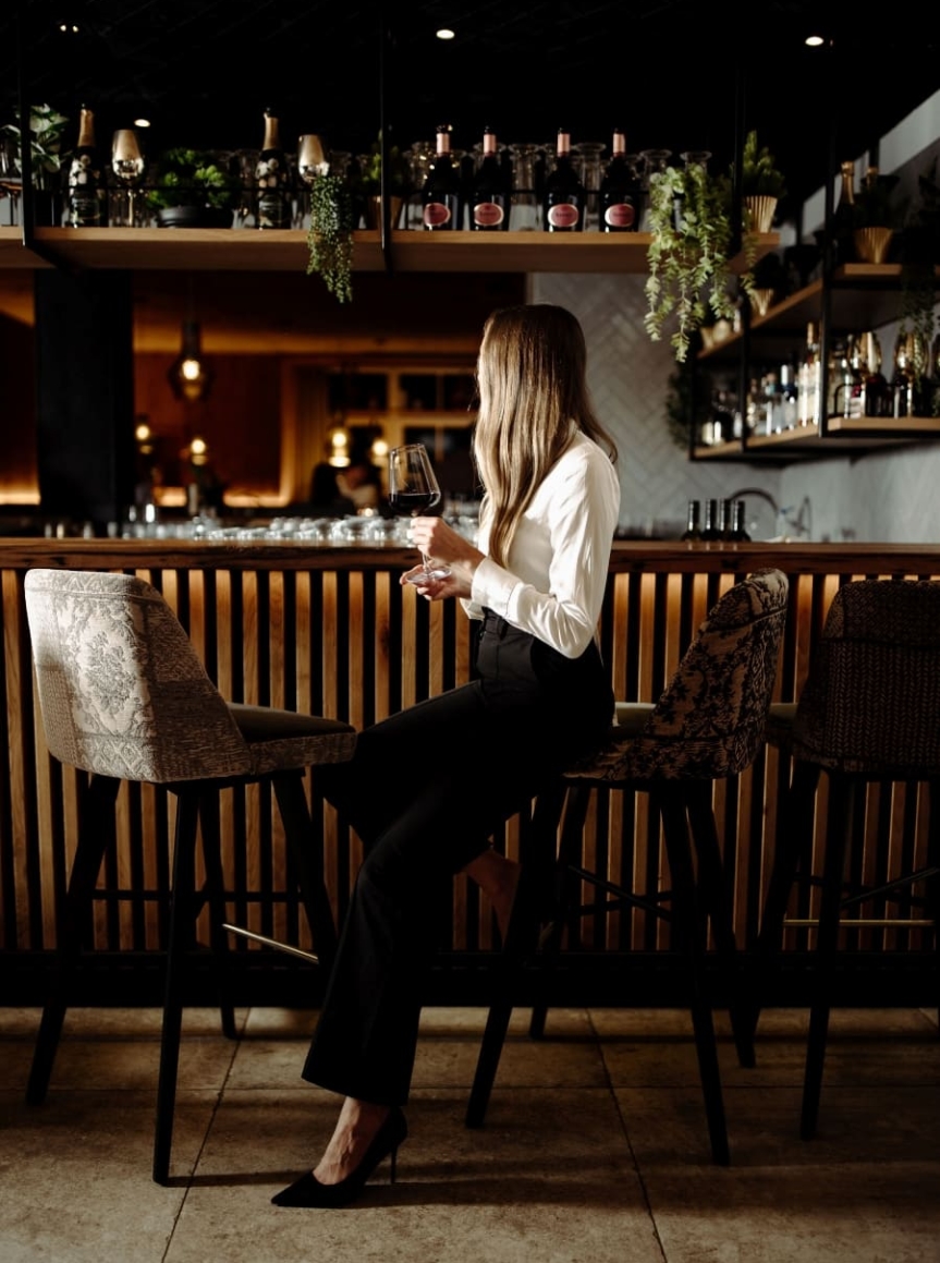 rau mit Cocktail an der modernen Bar im Resl, stilvoller Abend in entspannter Atmosphäre