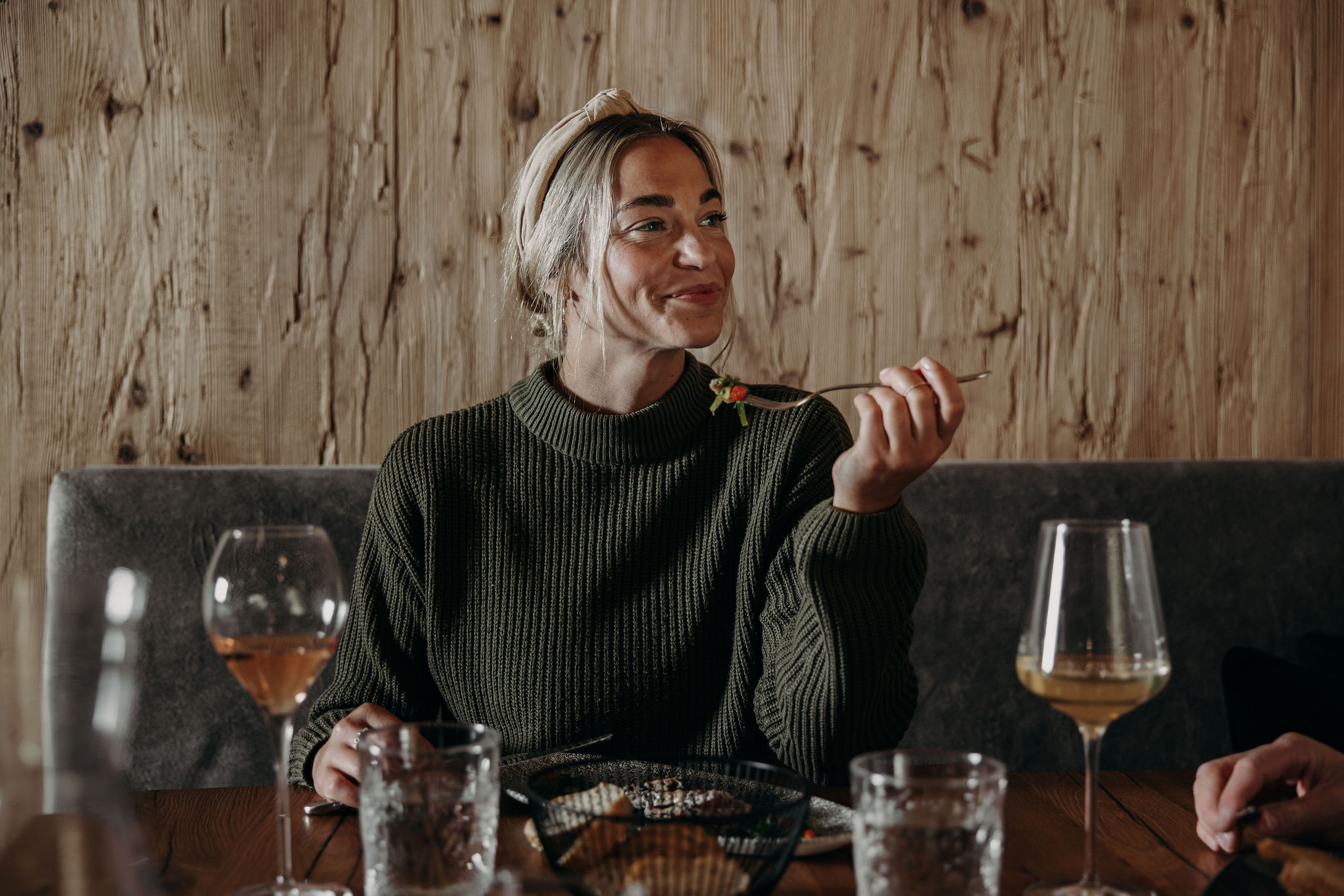 Woman enjoys dinner with wine in the hotel estaurant