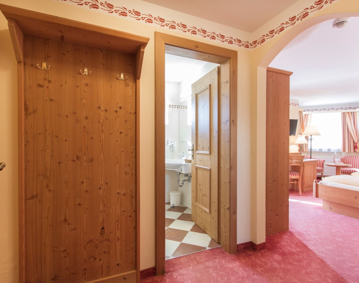 Flur eines Zimmers im Resl Resort mit Blick ins Badezimmer und Schlafzimmer